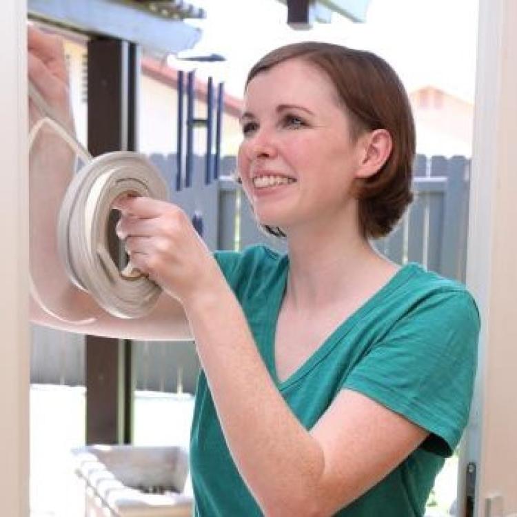 Person using weather stripping
